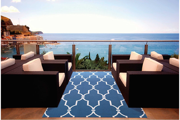 Add some excitement to any surrounding with these magnificent indoor/outdoor rugs. Floral, scrollwork, and animal-skin patterns in vivid color make this a truly eye-catching collection. These versatile rugs are beautiful to look at, soft to walk on, and easy to clean with just a hose. A high fashion grillwork design in a classic palette of navy blue and white. Expertly machine printed, a marvelously versatile indoor/outdoor rug for today's casual lifestyle. Easy to care for and perfect for almost any outdoor use. Just clean with a garden hose and enjoy years of lasting beauty.100% polyester | Power loomed | Serged edges | Low shedding | Easy to clean, simply rinse with a hose | Low pile | Imported