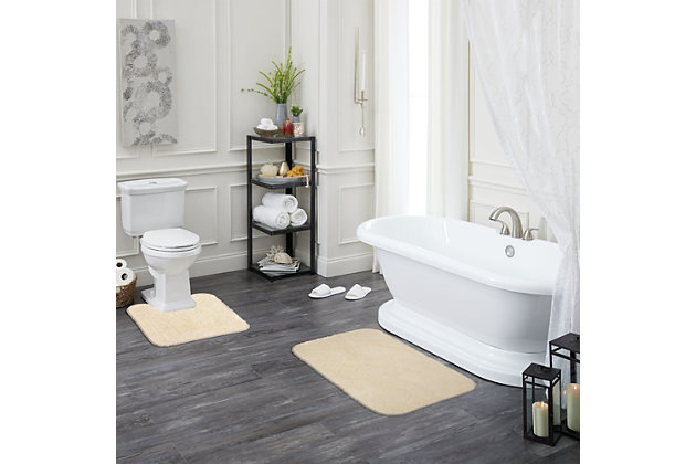 Create your own soothing spa-like experience with the Mohawk Cream Duo Bath Rug, available in size 1' 8"x1' 10". Durably designed with our machine tufted construction, this bath mat is crafted with stain resistant 100% nylon yarn and backed with the security of non-skid latex. Featuring a modern cream hue, this luxuriously soft bath rug will effortlessly add a cozy cushion of cloud-like comfort.Machine Tufted | Cut Pile | 100% Nylon | Made in the USA
