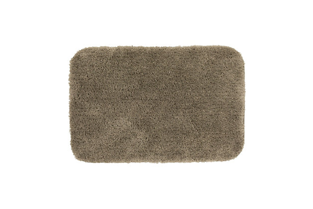 Create your own soothing spa-like experience with the Mohawk Taupe Duo Bath Rug, available in size 1' 8"x2' 8". Durably designed with our machine tufted construction, this bath mat is crafted with stain resistant 100% nylon yarn and backed with the security of non-skid latex. Featuring a modern tan hue, this luxuriously soft bath rug will effortlessly add a cozy cushion of cloud-like comfort.Machine Tufted | Cut Pile | 100% Nylon | Made in the USA