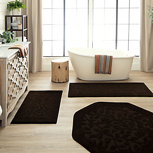Durable and lovely, the Wellington Collection of bath rugs feature a high-low, cut-and-loop design to create a sculpted all-over pattern of vine scrollwork. The heat set construction increases the products long lasting good looks. These rugs are washable and available in a wide array of colors to compliment your decor.Machine Tufted | Cut/Loop Pile | 100% Nylon | Made in the USA