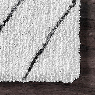 Sink into comfort with this modern shag. Boasting a wonderfully thick pile, each rug is machine made of polyester for a sumptuous feel underfoot. Having a sophisticated design makes this rug an ideal base for any contemporary decor.100% polyester | Hand tufted | Easy to clean and maintain | Unique hand crafted piece | Spot clean recommended | Imported