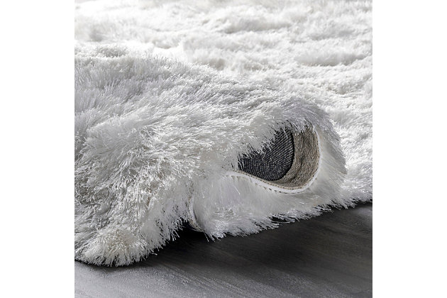 This glamorously shaggy rug features a wonderfully silky texture that radiates elegance. This style is hand tufted of polyester fibers that are luxuriously soft to the touch.100% polyester | Hand woven | Easy to clean and maintain | Unique hand crafted piece | Imported