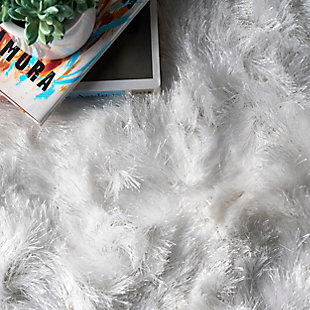 This glamorously shaggy rug features a wonderfully silky texture that radiates elegance. This style is hand tufted of polyester fibers that are luxuriously soft to the touch.100% polyester | Hand woven | Easy to clean and maintain | Unique hand crafted piece | Imported