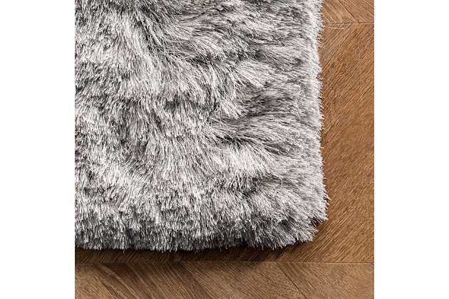 This glamorously shaggy rug features a wonderfully silky texture that radiates elegance. This style is hand tufted of polyester fibers that are luxuriously soft to the touch.100% polyester | Hand woven | Easy to clean and maintain | Unique hand crafted piece | Rug will shed; vacuum frequently | Imported