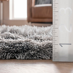 This glamorously shaggy rug features a wonderfully silky texture that radiates elegance. This style is hand tufted of polyester fibers that are luxuriously soft to the touch.100% polyester | Hand woven | Easy to clean and maintain | Unique hand crafted piece | Rug will shed; vacuum frequently | Imported
