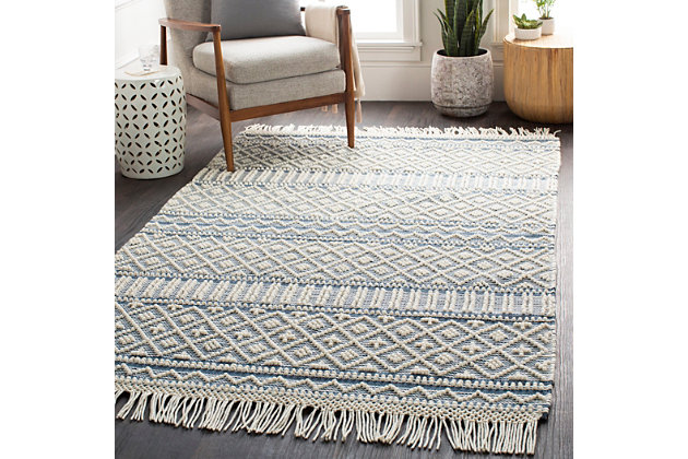 This stylish geometric rug with a farmhouse vibe, is the perfect option for a fresh update. Handmade in India with a blend of wool and cotton, this flat weave features cool neutral colors woven into a high-low pile for added texture and depth, then perfectly finished with a bold fringe accent. With just the right mix of classic, boho and modern, this design will bring interest and a stylish touch to any space.Hand Woven | 60% Wool, 40% Cotton | High/Low Textured Pile | Minimal Shedding | Imported