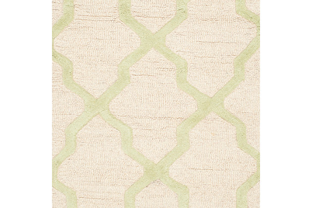 Freshen your living room, dining room, bedroom or entryway with the Safavieh Cambridge area rug, featuring an over-scaled Moroccan motif inspired by centuries-old artisan tile floors. Hand-tufted of superior wool for softness and durability, this simple but striking rug pairs different pile styles for interesting texture and dimension.Made of wool | Hand-tufted | Cotton backing; rug pad recommended | Wool fibers are prone to shedding, vacuum regularly and shedding will subside | Imported | Spot clean/dry clean recommended