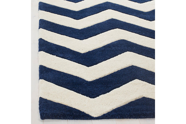 With its trendy chevron pattern, this Safavieh kids rug is buzzing with possibilities. Rest assured, it’s got a hand-tufted wool pile quality crafted for years of enjoyment and a cool, contemporary style they won’t soon outgrow.Made of wool | Hand-tufted | Rug pad recommended | Wool fibers are prone to shedding, vacuum regularly and shedding will subside | Imported | Spot clean/dry clean recommended