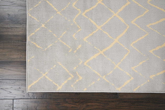 Playful and primitive, this grafix area rug from nourison features distressed cream-colored tribal rug patterns on a luxurious grey field. Each rug is power-loomed for simple care, superior wear, and a splendid look and feel, and will transform even the most ordinary room into something extraordinary.Serged edges | Easy-care fibers | Cut pile | Machine made | Power-loomed | Low shedding | Recommended for areas with moderate foot traffic | Indoor only | 100% polypropylene | Imported