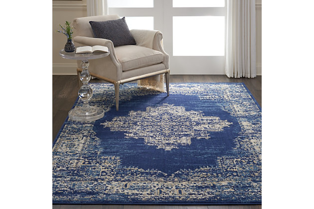 In intriguingly distressed shades of blue and white, this Grafix area rug from Nourison will elevate the elegance quotient of any room. Each rug is brilliantly bordered in traditional Persian rug style, and masterfully power loomed for a lavish feel, long wear, and low maintenance.Serged Edges | Easy-care fibers | Cut pile | Machine made | Power-loomed | Low shedding | Recommended for areas with moderate foot traffic | Indoor only | 100% Polypropylene | Imported | Backing: latex | Rug pad recommended | Vacuum regularly, clean spills immediately by blotting with a clean sponge or cloth. Professional cleaning recommended.