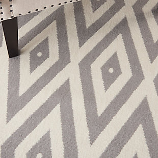 Concentric diamonds dazzle the eye in this boldly contemporary rug from the Grafix Collection by Nourison. The white-on-grey patterns are a mesmerizing addition to any room where you want to inject additional energy and sense of movement.Serged edges | Easy-care fibers | Cut pile | Machine made | Power-loomed | Low shedding | Recommended for areas with moderate foot traffic | Indoor only | 100% Polypropylene | Imported | Backing: latex | Rug pad recommended | Vacuum regularly, clean spills immediately by blotting with a clean sponge or cloth. Professional cleaning recommended.