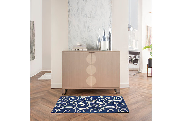 Curling vines form a lush abstract garden in this grafix collection area rug. This botanical style rug features ivory patterns on a rich navy blue field, with voluptuous curves creating a statement of soft comfort with artistic flair.Serged edges | Easy-care fibers | Cut pile | Machine made | Power-loomed | Low shedding | Recommended for areas with moderate foot traffic | Indoor only | 100% polypropylene | Imported