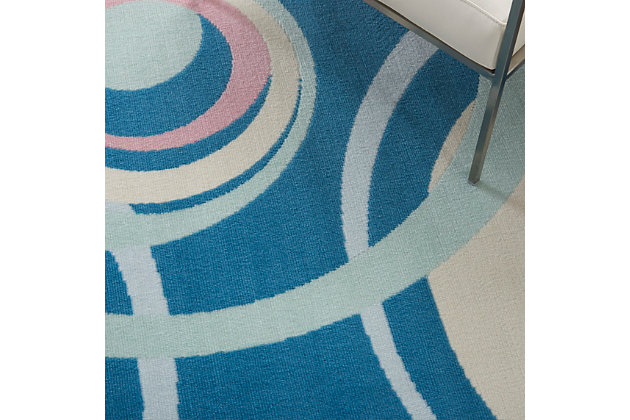 Concentric rings in a lively off-center pattern create a sense of spontaneity in this delightfully retro rug from the grafix collection. This contemporary design features a luxurious grey field with rings of white, pink, and pale blue on a rich blue field.Serged edges | Easy-care fibers | Cut pile | Machine made | Power-loomed | Low shedding | Recommended for areas with moderate foot traffic | Indoor only | 100% polypropylene | Imported