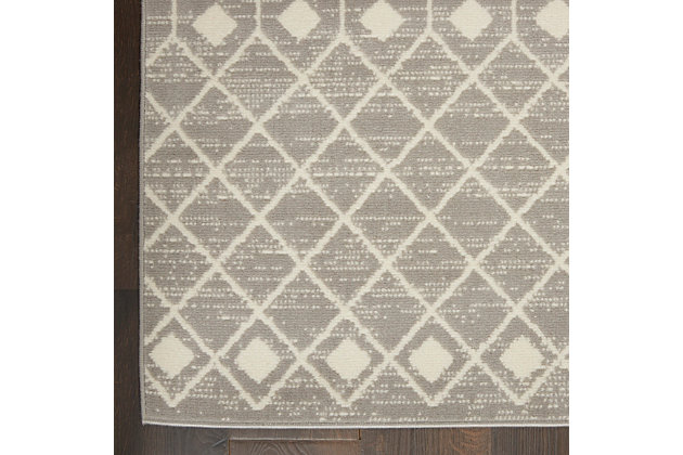 The Moroccan diamond bead pattern of this Grafix area rug creates a dimensional op-art look that draws the eye and pulls a room together. The soft combination of grey and ivory creates a subtle yet stunning focal point for the contemporary home.Serged edges | Easy-care fibers | Cut pile | Machine made | Power-loomed | Low shedding | Recommended for areas with moderate foot traffic | Indoor only | 100% Polypropylene | Imported