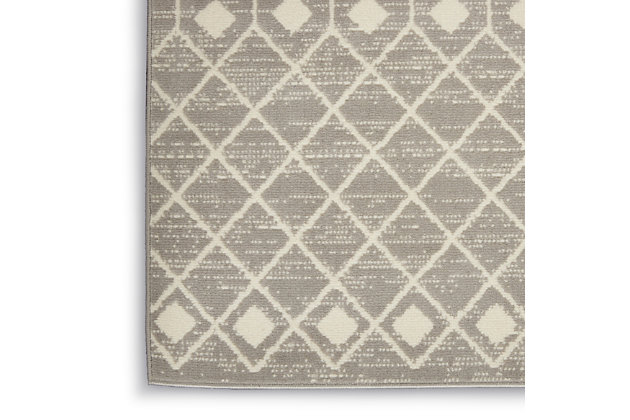 The Moroccan diamond bead pattern of this Grafix area rug creates a dimensional op-art look that draws the eye and pulls a room together. The soft combination of grey and ivory creates a subtle yet stunning focal point for the contemporary home.Serged edges | Easy-care fibers | Cut pile | Machine made | Power-loomed | Low shedding | Recommended for areas with moderate foot traffic | Indoor only | 100% Polypropylene | Imported