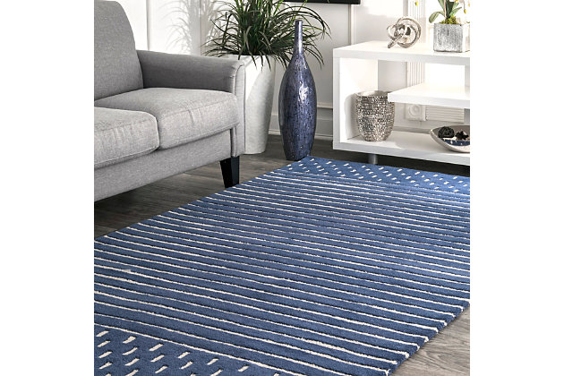 Made from the finest materials in the world and with the uttermost care, our rugs are a great addition to your home.Hand loomed | Imported | Material: 100% wool | Backing: canvas | Setting: indoor | Recommended rooms: bedroom, living room