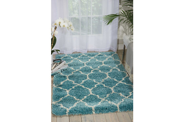 With its vintage pattern and engaging hues, this terrific accent rug exudes a hip, retro vibe that's sure to add an easy shot of style to any space. Warm, inviting and irresistibly textured for the ultimate in cozy comfort.Made of polypropylene and jute | Machine made | Power-loomed | Shag pile (more than 1" high) | Serged edges | Vacuum regularly; clean spills immediately by blotting with a clean damp sponge or cloth; professional cleaning recommended | Rug pad recommended | Recommended for areas with moderate foot traffic | Low shedding | Imported