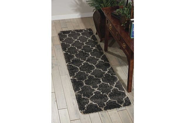 With its vintage pattern and captivating hues, this elegant runner exudes a retro vibe sure to add a shot of style to any space. Warm, inviting, and irresistably textured, it's the ultimate in cozy comfort.Made of jute | Machine made | Power-loomed | Shag pile (more than 1" high) | Serged edges | Vacuum regularly; clean spills immediately by blotting with a clean damp sponge or cloth; professional cleaning recommended | Rug pad recommended | Recommended for areas with moderate foot traffic | Low shedding | Imported
