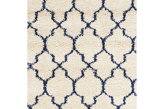 With its vintage pattern and rich hues, this wonderful rug exudes a retro vibe sure to add a shot of style to any space. Warm, inviting, and irresistably textured, it's the ultimate in cozy comfort.Made of jute | Machine made | Power-loomed | Shag pile (more than 1" high) | Serged edges | Vacuum regularly; clean spills immediately by blotting with a clean damp sponge or cloth; professional cleaning recommended | Rug pad recommended | Recommended for areas with moderate foot traffic | Low shedding | Imported
