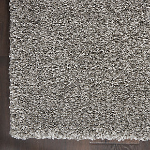 Sink your feet into the deep, dense shag of this Ashland area rug, and you will be seduced by its textural appeal. Its soft fibers are beautifully dyed in medium gray tones with a marbleized effect for visual impact. The cool and contemporary borderless design adds modern chic to any room.Made of polypropylene | Machine made; power loomed | Backed with latex | Serged edges | Low shedding | Low pile | Vacuum regularly; no beater bar | Rug pad recommended | Imported