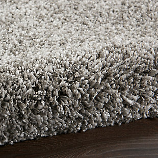 Sink your feet into the deep, dense shag of this Ashland area rug, and you will be seduced by its textural appeal. Its soft fibers are beautifully dyed in medium gray tones with a marbleized effect for visual impact. The cool and contemporary borderless design adds modern chic to any room.Made of polypropylene | Machine made; power loomed | Backed with latex | Serged edges | Low shedding | Low pile | Vacuum regularly; no beater bar | Rug pad recommended | Imported