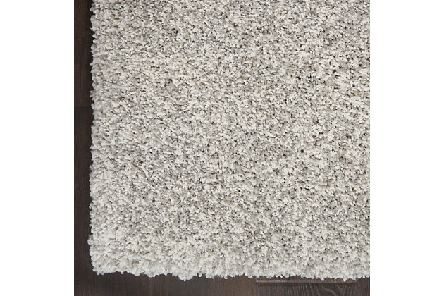 Sink your feet into the deep, dense shag of this Ashland area rug, and you will be seduced by its textural appeal. Its modern fibers are beautifully dyed in soft white and gray tones for a subtle marbleized effect. The cool and contemporary borderless design adds instant chic to any room.Made of polypropylene | Machine made; power loomed | Backed with latex | Moderate shedding | Shag pile | Vacuum regularly; no beater bar | Rug pad recommended | Imported