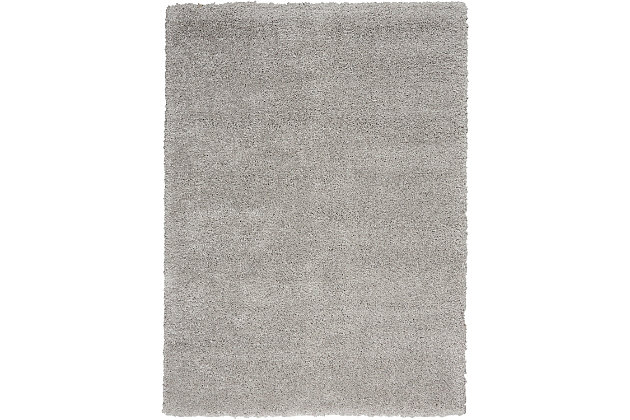 Light, silvery tones create a wash of luminous color that brings the deep, soft texture of this Ashland area rug to life. It's power loomed with modern fibers for effortless beauty. The neutral tone and borderless design will enhance all kinds of decor, from traditional to contemporary.Made of polypropylene | Machine made; power loomed | Backed with latex | Moderate shedding | Shag pile | Vacuum regularly; no beater bar | Rug pad recommended | Imported