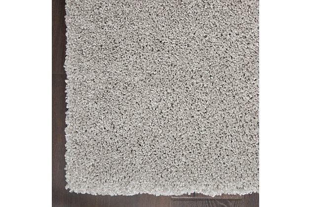 Light, silvery tones create a wash of luminous color that brings the deep, soft texture of this Ashland area rug to life. It's power loomed with modern fibers for effortless beauty. The neutral tone and borderless design will enhance all kinds of decor, from traditional to contemporary.Made of polypropylene | Machine made; power loomed | Backed with latex | Moderate shedding | Shag pile | Vacuum regularly; no beater bar | Rug pad recommended | Imported