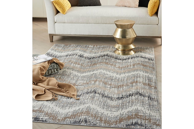 The abstract jagged chevron pattern of this Elation Collection area rug creates a sense of movement in modern and contemporary settings. Cool gray, charcoal, ivory, beige and brown hues add a unique touch to your living room, bedroom or home office. 
Made of polypropylene and polyester | Machine made; power loomed | Backed with latex | Serged edges | Low shedding  | Low pile | Vacuum regularly; no beater bar | Rug pad recommended | Imported