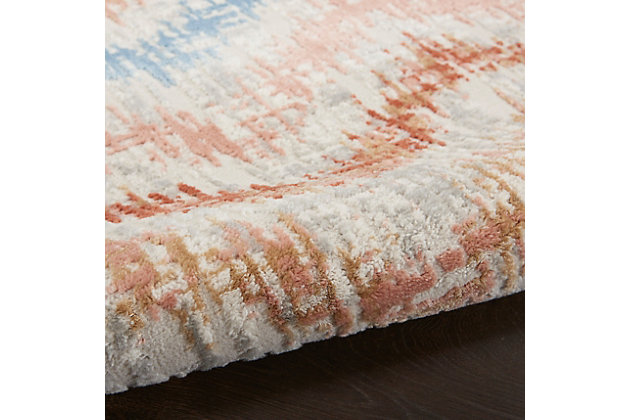 The abstract jagged chevron pattern of this Elation Collection area rug creates a sense of movement in modern and contemporary settings. Cool gray, deep red, ivory, blue and rust orange hues add a unique touch to your living room, bedroom, or home office.Made of polypropylene and polyester | Machine made; power loomed | Backed with latex | Serged edges | Low shedding | Low pile | Vacuum regularly; no beater bar | Rug pad recommended | Imported