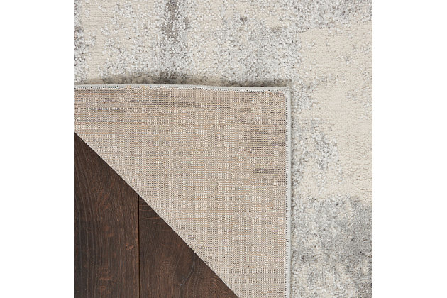 Ultra-modern art for your floors, this Elation area rug is just what you need to elevate your surroundings. Bold strokes of gray, ivory and brick red evoke a sophisticated aura designed to command attention in contemporary settings. It’s an ideal foundation for your living room, bedroom, dining room, hallway or home office.Made of polypropylene and polyester | Machine made; power loomed | Backed with latex | Serged edges | Low shedding | Low pile | Vacuum regularly; no beater bar | Rug pad recommended | Imported