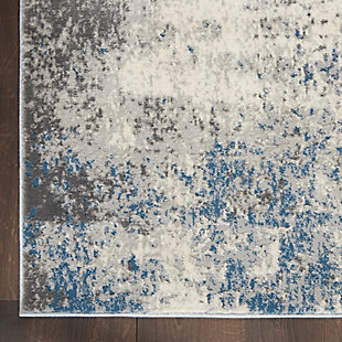 Infuse urban energy into your home with this kathy ireland® Home Grand Expressions area rug. Neutral gray, ivory and blue hues meld together in smooth abstract fashion for a refreshing color effect in contemporary settings.Made of polypropylene and polyester | Machine made; power loomed | Backed with latex | Serged edges | Low shedding | Low pile | Vacuum regularly; no beater bar | Rug pad recommended | Imported