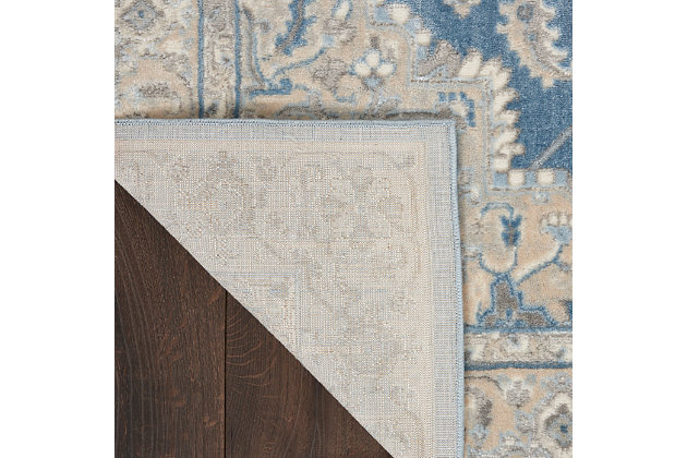 Tawny beige and gently muted blue make a marvelous, contemporary color combination for this area rug from kathy ireland® Home. The intricate traditional design, gently faded surface effect and indulgent softness evoke feelings of warmth and elegance in your living room, family room, bedroom, home office or dining room. This fabulous rug, part of the Grand Villa collection, features an ornamental border.Made of polypropylene and polyester | Machine made; power loomed | Backed with latex | Serged edges | Low pile | Low shedding | Vacuum regularly; no beater bar | Rug pad recommended | Imported
