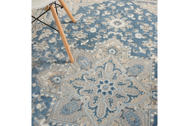Tawny beige and gently muted blue make a marvelous, contemporary color combination for this area rug from kathy ireland® Home. The intricate traditional design, gently faded surface effect and indulgent softness evoke feelings of warmth and elegance in your living room, family room, bedroom, home office or dining room. This fabulous rug, part of the Grand Villa collection, features an ornamental border.Made of polypropylene and polyester | Machine made; power loomed | Backed with latex | Serged edges | Low pile | Low shedding | Vacuum regularly; no beater bar | Rug pad recommended | Imported