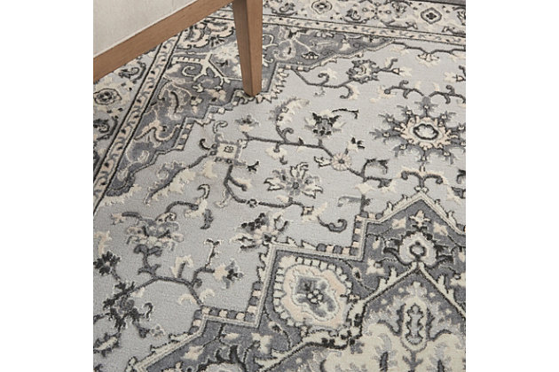 This kathy ireland® Home Grand Villa rug commands attention with a center medallion Persian floral design and stately ornamental border. Soft and sumptuous in subtle shades of gray, it creates a vintage look with modern appeal. The versatile piece is ideal for decorating the traditional, contemporary or eclectic room.Made of polypropylene and polyester | Machine made; power loomed | Backed with latex | Serged edges | Low pile | Low shedding | Vacuum regularly; no beater bar | Rug pad recommended | Imported