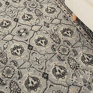 Bring grandeur to your favorite room with this Grand Villa area rug by kathy ireland® Home. Its traditional allover Persian design features botanical motifs and the opulence of an ornate border. The rug merges a vintage look with the modern touch of a tonal, warm gray palette. Made of polypropylene and polyester | Machine made; power loomed | Backed with latex | Serged edges | Low pile | Low shedding | Vacuum regularly; no beater bar | Rug pad recommended | Imported