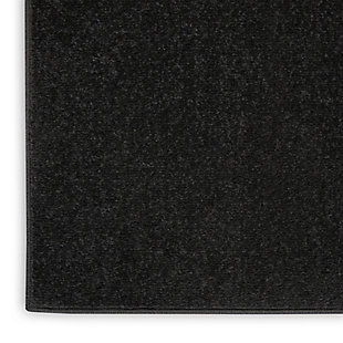 Here’s an indoor-outdoor area rug by Nourison Essentials that has it all. This contemporary, borderless rug in solid, sophisticated black is an ideal choice for gathering places around your home. Designed for active lifestyles, it will withstand heavy traffic without sacrificing comfort. To extend its life, bring it indoors during extreme weather.Made of polypropylene | Machine made; power loomed | Backed with latex | Suitable for indoor/outdoor use  | Low pile | Low shedding | Vacuum regularly; no beater bar | Rug pad recommended | Imported