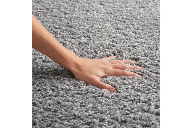 You’ll be floating on air with the cloudlike softness and misty gray tones of this Shangri-La shag area rug. Densely structured to create textured shadow and light, the rug exudes casual elegance.Made of polypropylene | Machine made; power loomed | Backed with jute | Serged edges | Shag pile | Low shedding | Rug pad recommended | Vacuum regularly; no beater bar | Imported