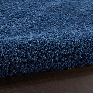 This Shangri-La shag area rug invites you to step into a pool of softness, in a rich and seductive navy blue. Densely structured to create textured shadow and light, this rug exudes casual elegance.Made of polypropylene | Machine made; power loomed | Backed with jute | Serged edges | Shag pile | Low shedding | Rug pad recommended | Vacuum regularly; no beater bar | Imported
