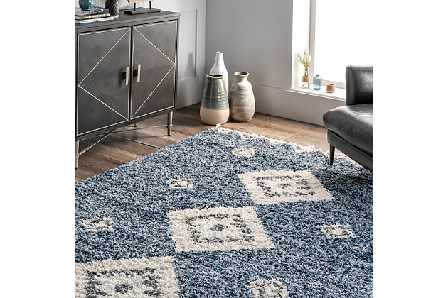 Step into comfort with the luxuriously soft and fluffy texture of this rug that simply has it all. You are sure to enjoy its contemporary style, plush pile, and braided tassel edges. The perfect addition to any space in your home that needs a touch of style and comfort, you may just find yourself relaxing directly on this rug. Machine-made of polypropylene to ensure durability and ease of care.100% polypropylene | High pile (1.5") | Step into comfort with the soft and fluffy texture of a shag rug | The perfect cozy rug for your bedroom, living room, or hallway | Fresh and of the moment, this contemporary rug adds the right amount of chic to your space | Easy to care for (we recommend vacuuming regularly to reduce potential shedding; spot clean any stains with carpet cleaner) | Includes 3" braided tassels on both ends | Imported
