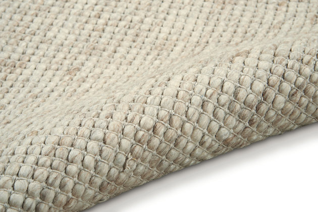 In creamy ivory and white tones, this hand woven natural Calvin Klein Lowland wool area rug merges understated color with striking design and a stunning surface texture to offer a modern, minimalist layer of laidback luxury to any interior.43% Wool, 29% Cotton, 14% Polyester, 7% Rayon, 7% Nylon | Imported | Handcrafted | Flat weave | Handmade | Tufted | Moderate shedding | Recommended for areas with heavy foot traffic | Rectangle | Indoor only