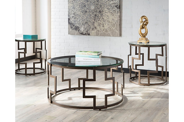 Frostline coffee table set takes a cool twist on contemporary style. Drum form metal bases sport a graphic keyway design that’s so striking. Clear glass tabletops naturally enhance the open and airy mood.1 coffee table and 2 end tables | Made of tubular metal and clear tempered glass | Bronze-tone base finish | Assembly required | Clean with a soft, dry cloth | Estimated Assembly Time: 45 Minutes
