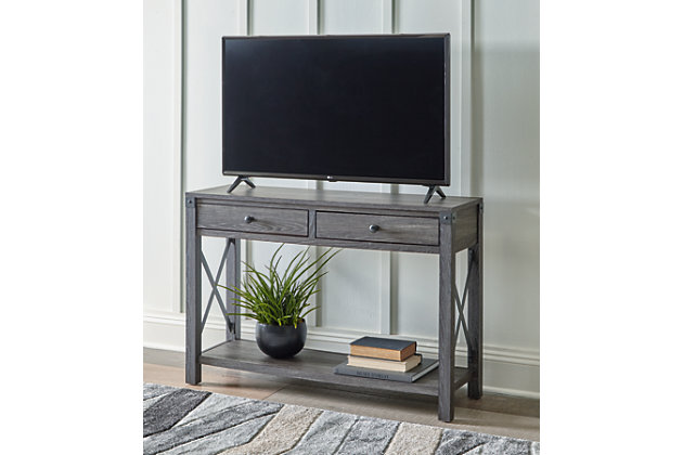 Open the door to modern farmhouse style with the Freedan console table. The beautiful woodgrain look and classic crossbuck metal accents are a cool touch, while the lower shelf provides surface space for fashionable home accessories. A pair of smooth-gliding drawers is the answer to the daily, where-are-my-keys question.Made of metal and engineered wood | Gray decorative wood grain laminate | Metal crossbuck accents | 2 smooth-gliding drawers | Fixed lower shelf | Assembly required | Estimated Assembly Time: 45 Minutes
