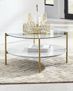 Add a bright spot to your contemporary space with the Wynora cocktail table. A clear glass top provides a great view of the replicated Carrara marble shelf below. A goldtone finish on the metal frame heightens the modern aesthetic.Made of decorative laminate, engineered wood and glass | Clear glass top insert | 1 lower shelf made with decorative laminate over engineered wood | White faux marble top and shelf | Goldtone metallic metal frame | Assembly required | Estimated Assembly Time: 15 Minutes