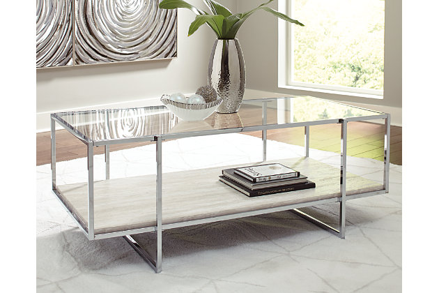 Contemporary style gets a modern attitude in the Bodalli cocktail table. A tempered glass top showcases the replicated travertine stone shelf. The box design of the metal frame creates open space to offer the illusion of more room.Made of engineered wood and decorative laminate | Tempered glass top | Chrome-tone metal frame | Faux travertine marble shelf | Assembly required | Estimated Assembly Time: 30 Minutes