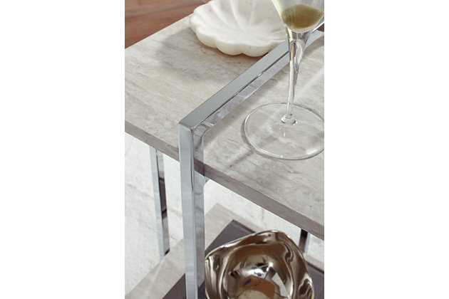 Contemporary style gets a modern attitude in the Bodalli side table. The replicated travertine stone shelf offers chic sophistication, while the box design of the metal frame creates open space to offer the illusion of more room.Made of engineered wood and decorative laminate | Chrome-tone metal frame | Faux travertine marble top and shelf | Assembly required | Estimated Assembly Time: 15 Minutes