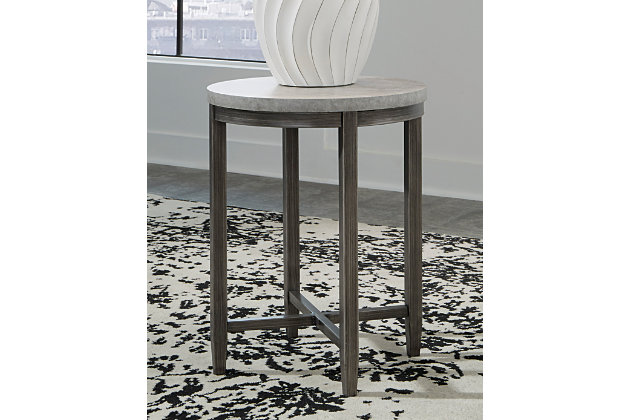 With its casual, linear style design, the Shybourne round end table is a sleek, chic accompaniment to your sofa or sectional seating area. Features faux concrete melamine top with metal base in a dark pewter-tone finish.Faux concrete melamine top | Metal base in dark pewter-tone finish | Assembly required | Estimated Assembly Time: 15 Minutes