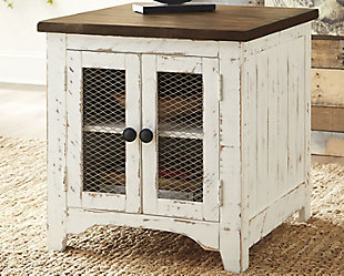 Double take. Sporting a two-tone finish that pairs a distressed vintage white with aged natural pine color, the Wystfield end table elevates the art of rustic farmhouse living. Enhancing its charm: shelved storage visible through cabinet doors with inset metal grills.Made of veneers, wood and engineered wood | Distressed finish; vintage white and aged natural pine color | Double door cabinet with metal grills and hardware | Center shelf | Assembly required | Estimated Assembly Time: 30 Minutes