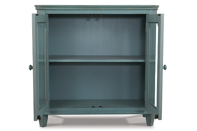 With its distressed vintage paint finish, fluted details and French provincial mouldings, the exquisite Mirimyn glass-front cabinet is sure to grace your space in such a très chic way. Adjustable shelved storage makes this versatile cabinet that much more practical.Made of veneers, wood and engineered wood | 2 cabinet doors with glass inlays revealing an adjustable shelf | Assembly required | Excluded from promotional discounts and coupons | Estimated Assembly Time: 30 Minutes