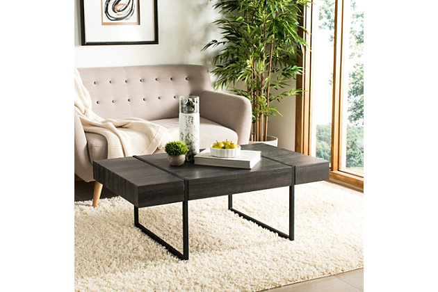 Striking and stylish, the urban industrial design of this rectangular coffee table ensures its place in any contemporary living space. Its minimalist lines are highlighted with a chic black finish that allows the beauty of the wood grain to steal the show.Made of engineered wood | Black finish | Black powdercoat metal legs | Clean with a soft, dry cloth | Assembly required